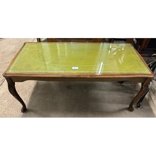 327 - A mahogany and green leather topped coffee table