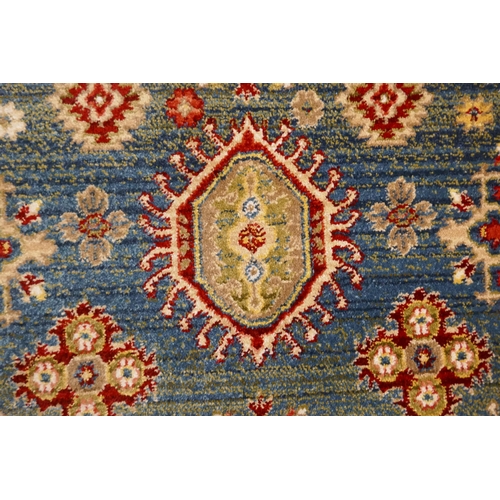 1323 - A blue ground full pile rug with all over Aztec design, 230 x 160cm