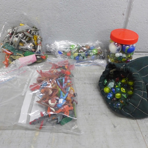 1064 - A collection of marbles and plastic toy soldiers, cowboys, Indians, etc. **PLEASE NOTE THIS LOT IS N... 