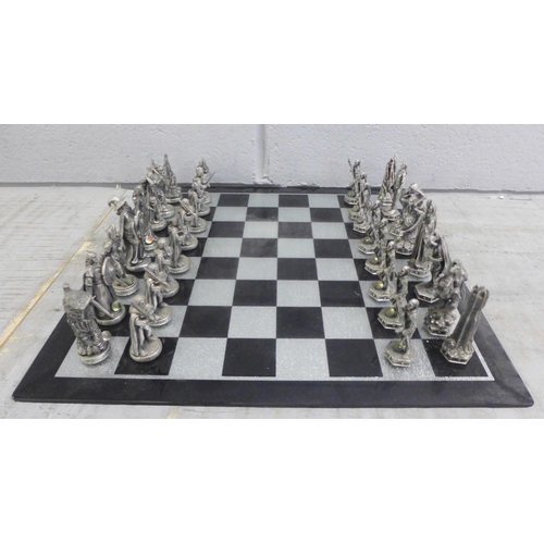 1069 - A Lord of The Rings pewter chess et by Tudor Mint, complete with glass board and pieces, in original... 