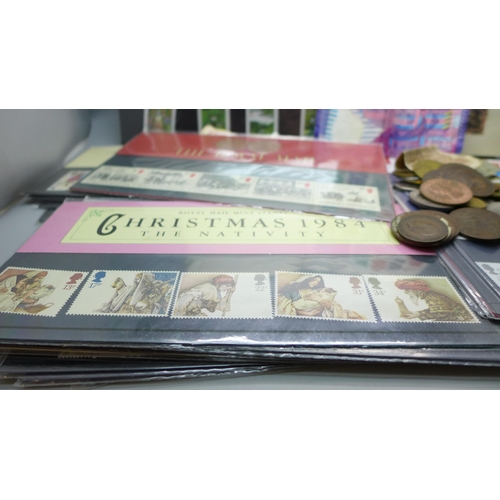 606 - Twenty-one Royal Mail mint stamps and assorted coins, banknotes and album