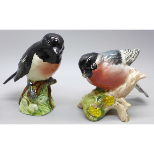 613 - Four Beswick Pottery birds; bullfinch, stonechat, goldcrest and blue tit, a Goebel bird and a studio... 