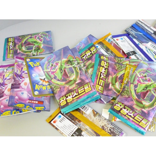 664 - Open packs of Pokemon cards, Japanese and English and Pokemon stickers