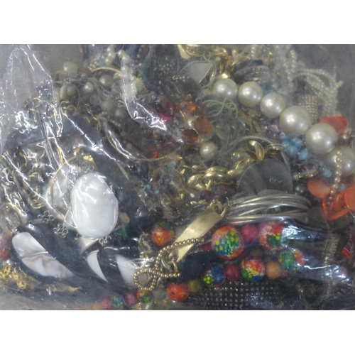 690 - A large bag of mixed costume jewellery, approximately 8kg