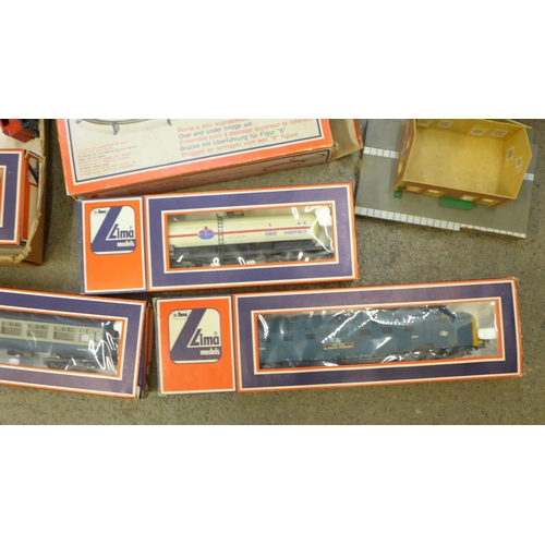 706 - A collection of model rail accessories; transformer, platform, station, train tracks, Lima Amoco She... 