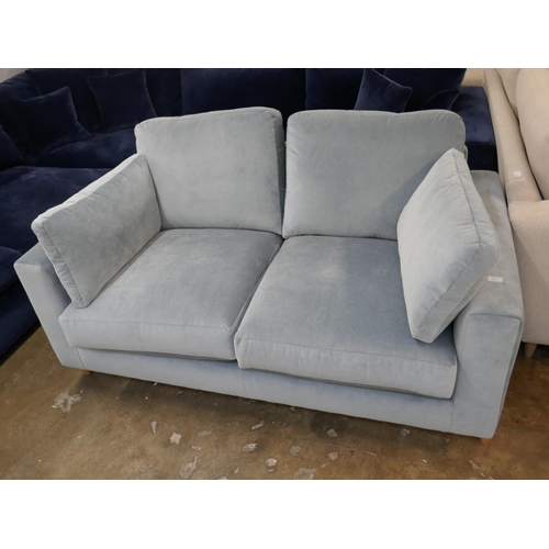 1410 - A steel blue velvet two seater sofa on semi exposed frame