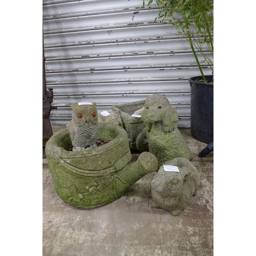 2227 - Three concrete animal figure garden ornaments including a rabbit, dog and owl. A concrete watering c... 