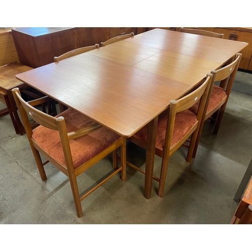 22 - A teak extending dining table and six chairs