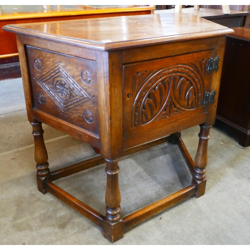 184 - A carved oak credence cupboard