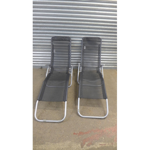 2202 - Two metal and black fabric folding sun loungers