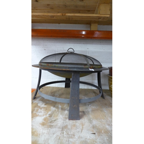 2236 - A metal fire pit with four assorted metal post spikes and a manual mitre saw