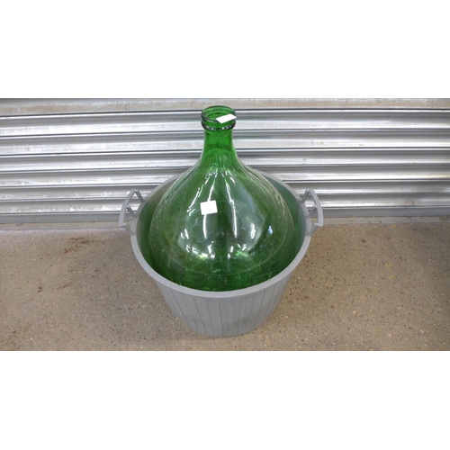 2253 - A large green glass carboy jar in plastic basket