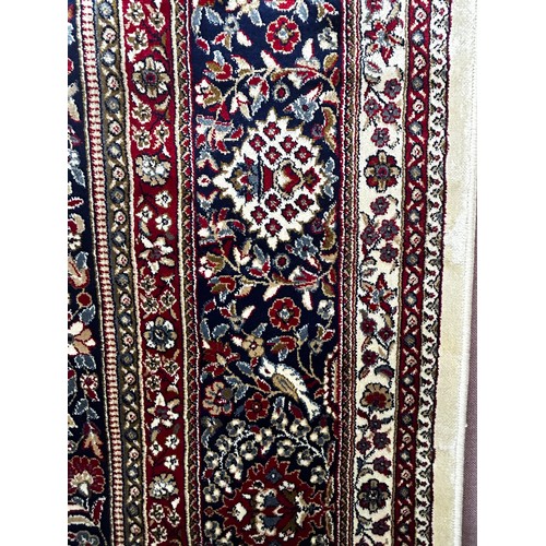 1489 - A large ivory ground Cashmere carpet with traditional floral medallion, 330 x 240