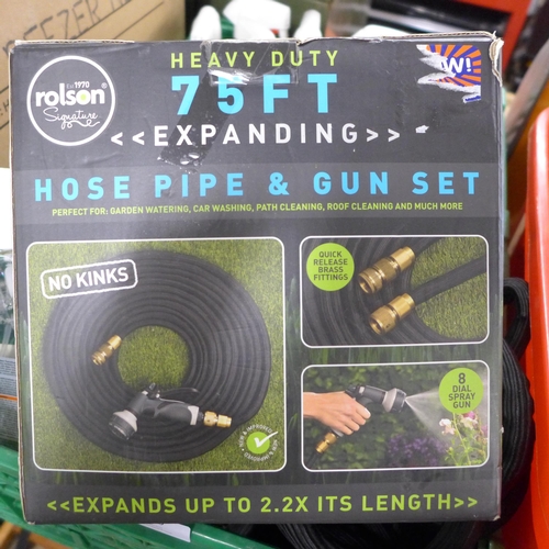 2319 - Approx. 30 bottles of Tesco wooden furniture cleaner and two hose pipes