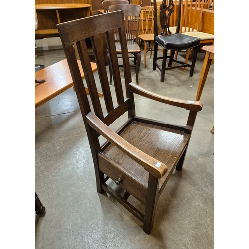 128 - A Scottish Arts and Crafts oak chair, designed by Sir Robert Stodart Lorimer