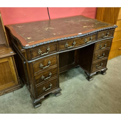 133 - An Edward VII Chippendale style mahogany and leather topped serpentine desk