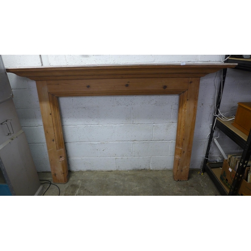 2144 - A 210cm x 137cm pine fire surround with tiled top