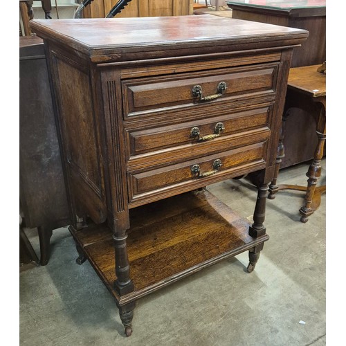 223 - A Victorian Aesthetic Movement oak three drawer chest