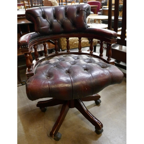 125 - A mahogany and burgundy leather revolving captain's desk chair