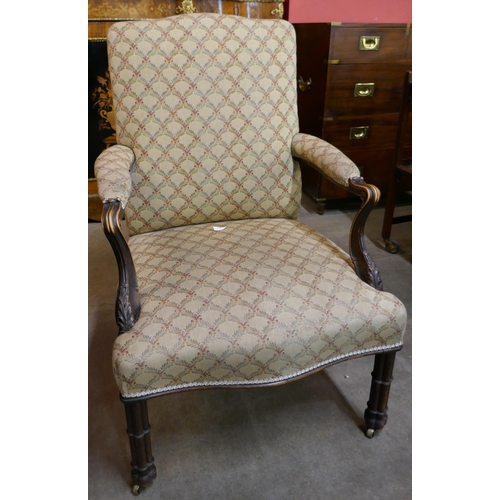 129 - A George III Chippendale style carved mahogany and fabric upholstered Gainsborough chair