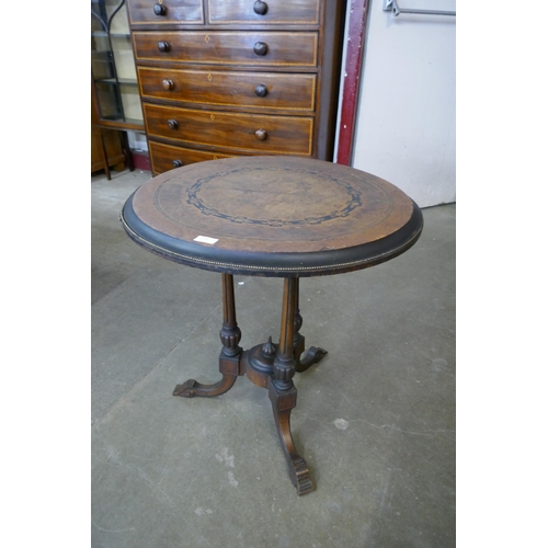 138 - A Victorian Aesthetic Movement marquetry inlaid figured walnut circular tilt top centre table