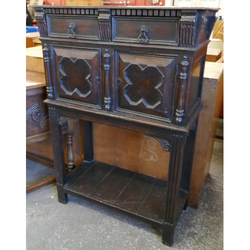 186 - An early 20th Century Jacobean Revival oak cupboard on stand