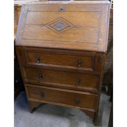 193 - A carved oak bureau