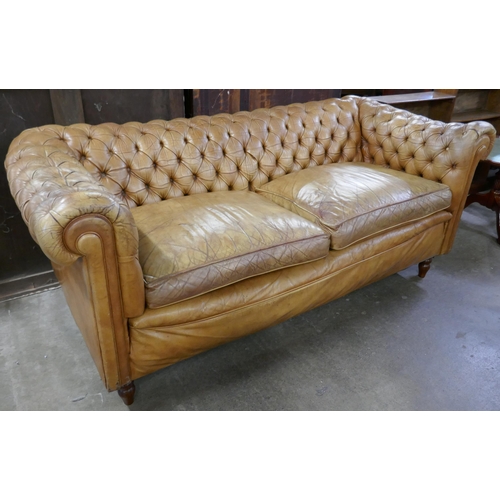 199 - A tan leather Chesterfield settee