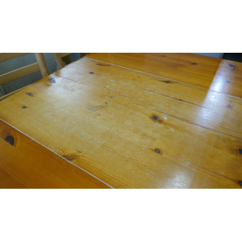 1554 - A pine table and four chairs