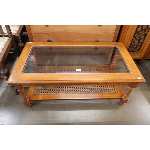 246 - A glassed topped beech coffee table