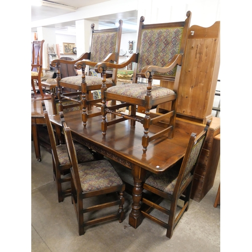 251 - A 17th Century style carved oak refectory table and six chairs