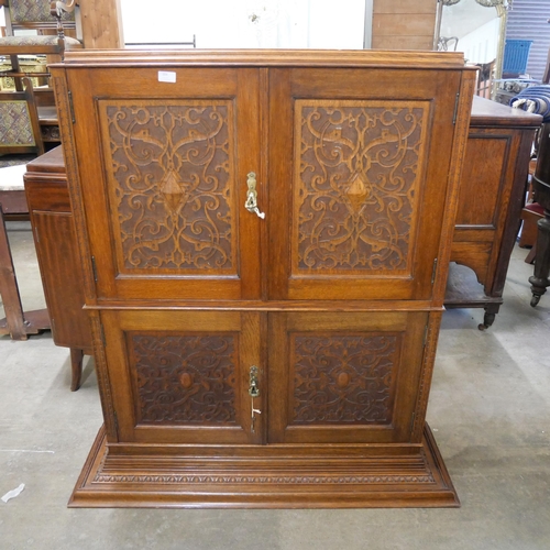 204 - A Victorian James Plucknett & Co. carved oak wall hanging four door cupboard