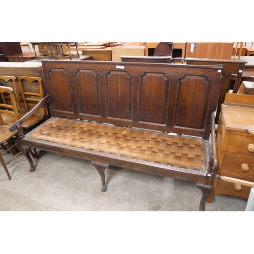 231 - A George III panelled oak settle