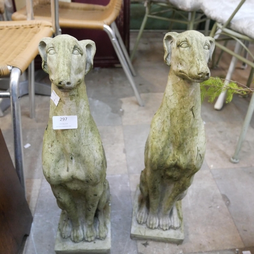 297 - A pair of concrete garden figures of seated greyhounds