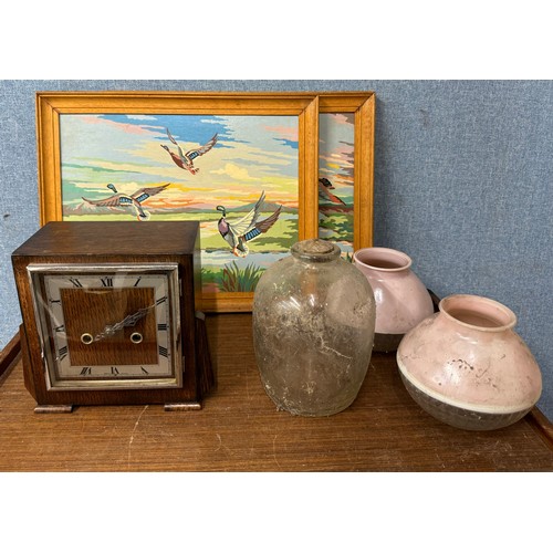 369 - An Art Deco oak mantel clock, lamp shades, two oils on board and a glass jar