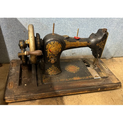 379 - A cased sewing machine, sewing box and a footstool