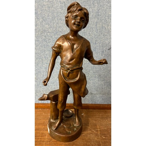 381 - A French bronze figure of a girl blacksmith