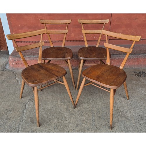 7 - A set of four Ercol Blonde elm and beech green dot stacking chairs