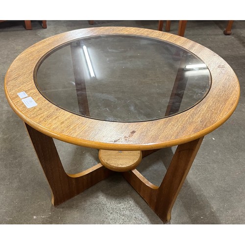 14 - A teak and glass topped circular coffee table