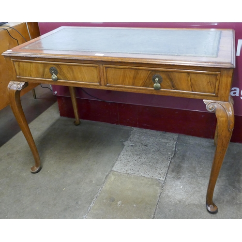 130 - A Queen Anne walnut and green leather topped two drawer writing table