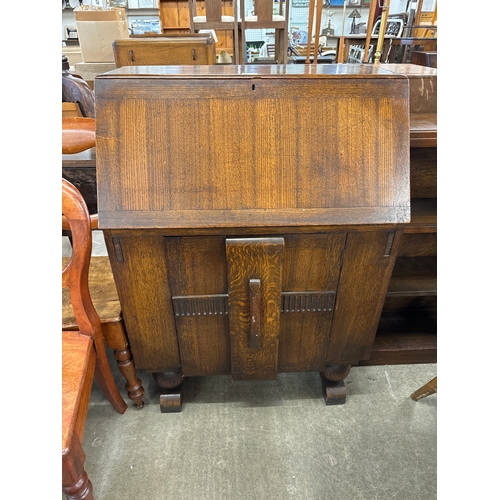 214 - An Art Deco carved oak bureau