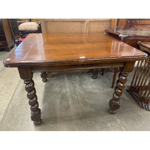 216 - An early 20th Century oak barleytwist dining table