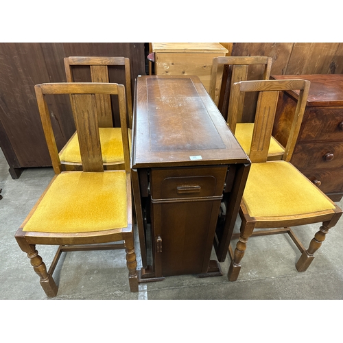 230 - An oak drop-leaf table and four chairs