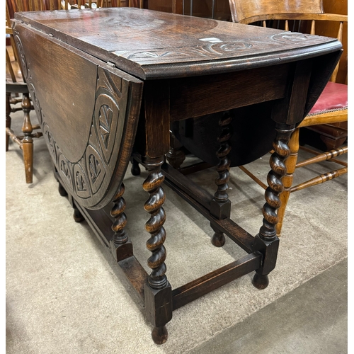 236 - An early 20th Century carved oak gateleg table