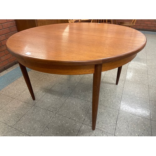 25 - A G-Plan Fresco teak circular extending dining table