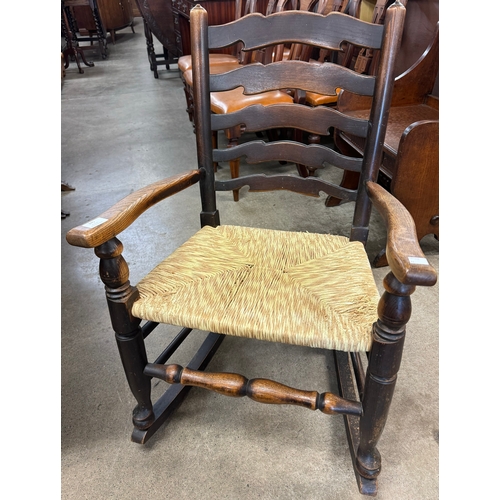 245 - An 18th Century style elm rush seated rocking chair