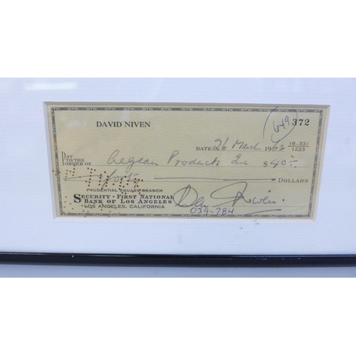 608 - A David Niven signed cheque and photograph display with Rutland Autographs AFTAL registered C.O.A.