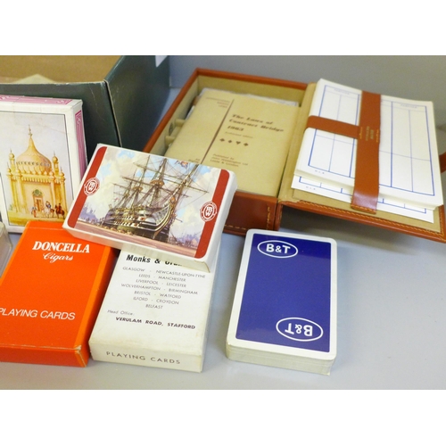 662 - A leather cased Bridge set and a collection of playing cards (some unused)