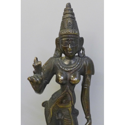 677 - A bronze model of an Indian Goddess, Parvati Devi and a horn and rosewood model of a bird