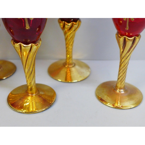 690 - A set of six Bohemian ruby glass and gold wines